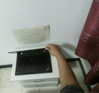 First-person HOI4D frame showing a hand opening a laptop on a cabinet; cropped from the authors’ pose-tracking example, CC BY-NC 4.0